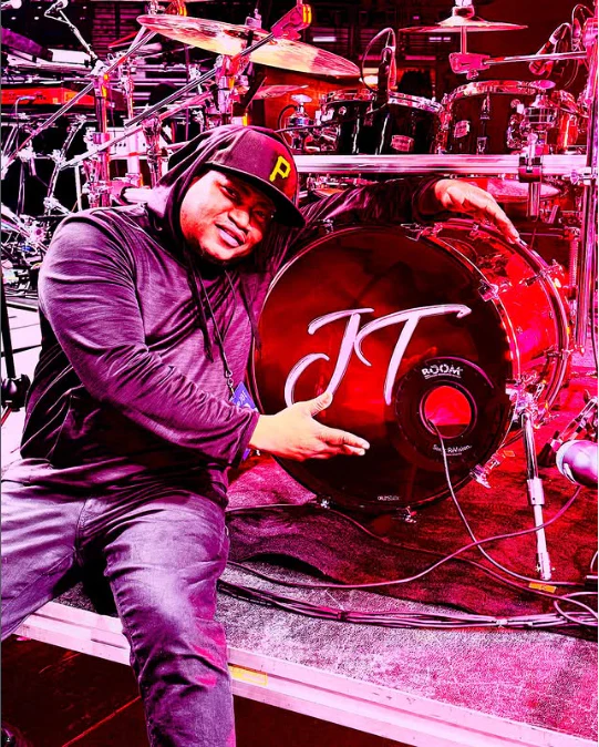 Willie Bam Bam Parker at his drum kit under purple stage lights